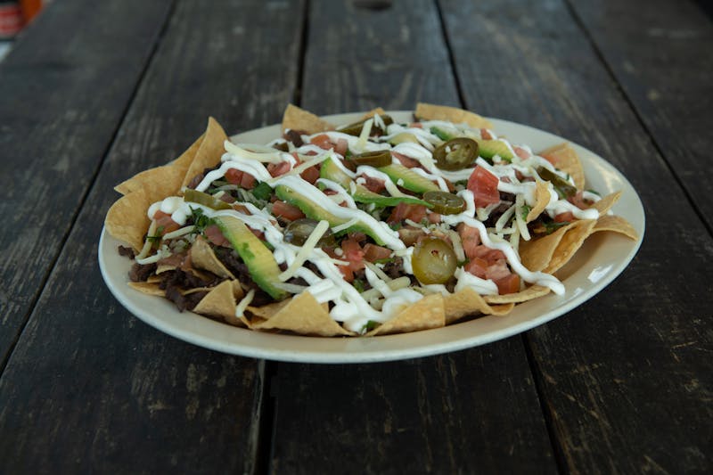Loaded Nachos with melted cheese, jalapeños and sour cream