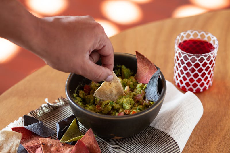 Fresh Guacamole and Chips with ripe avocados and lime